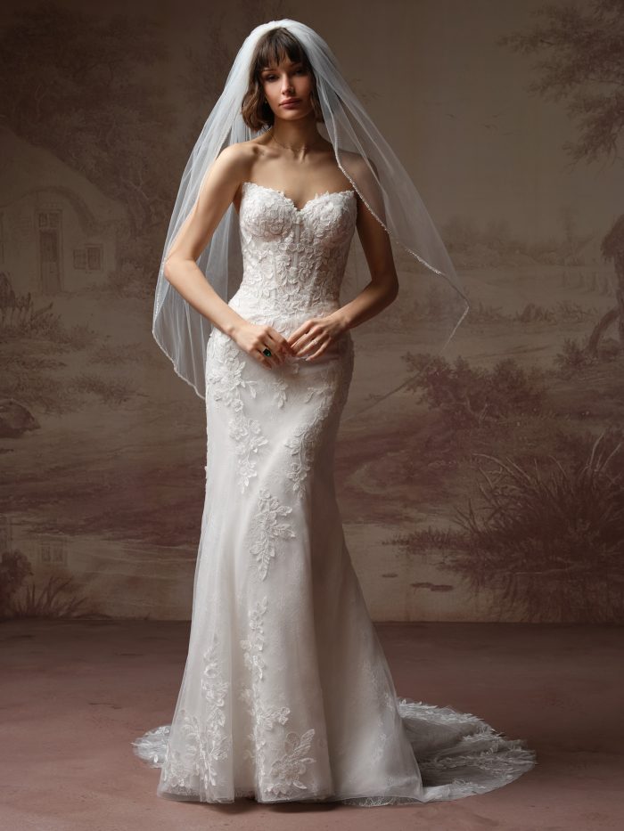 Santorini by Maggie Sottero veil from the Essentials Edit, showcasing a light, airy fingertip-length tulle veil with clean edge detail styled over a lace fit-and-flare wedding gown.