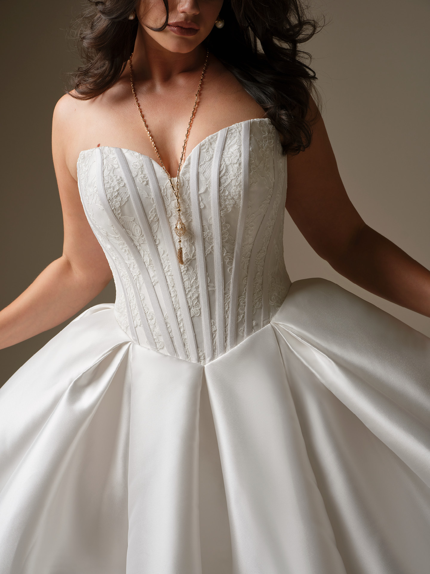 Maggie Sottero Ashland ballgown wedding dress featuring a strapless basque waist corset with lace detailing and structured boning, paired with a full satin skirt for a sculpted, waist-enhancing silhouette.