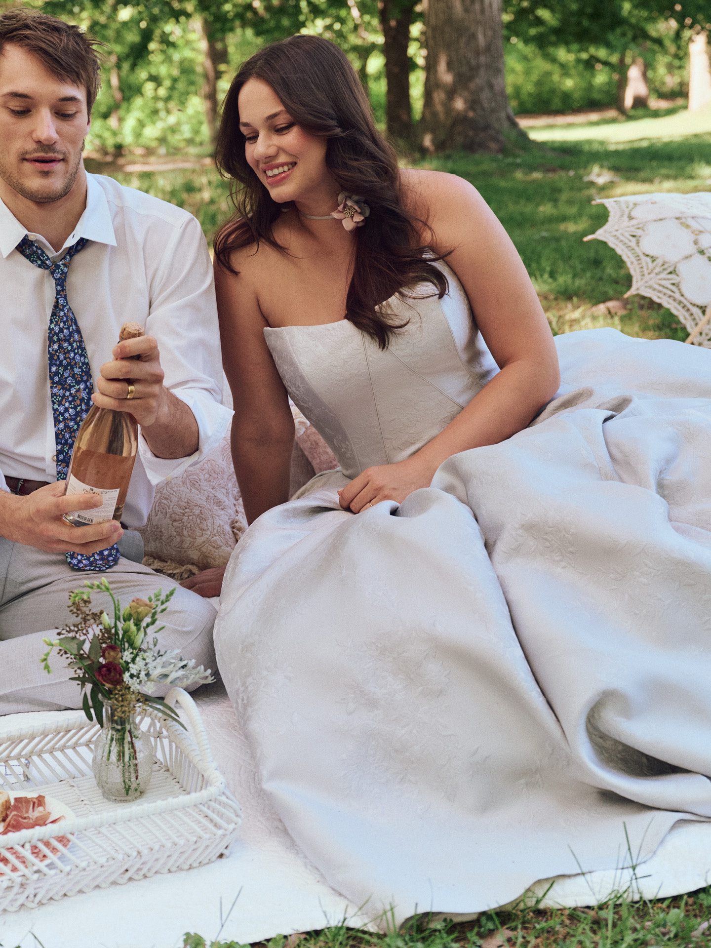 Bride wearing Maggie Sottero Fortune Marie ballgown wedding dress with a strapless bodice and full textured skirt, styled for an outdoor setting with a soft, modern romantic feel.