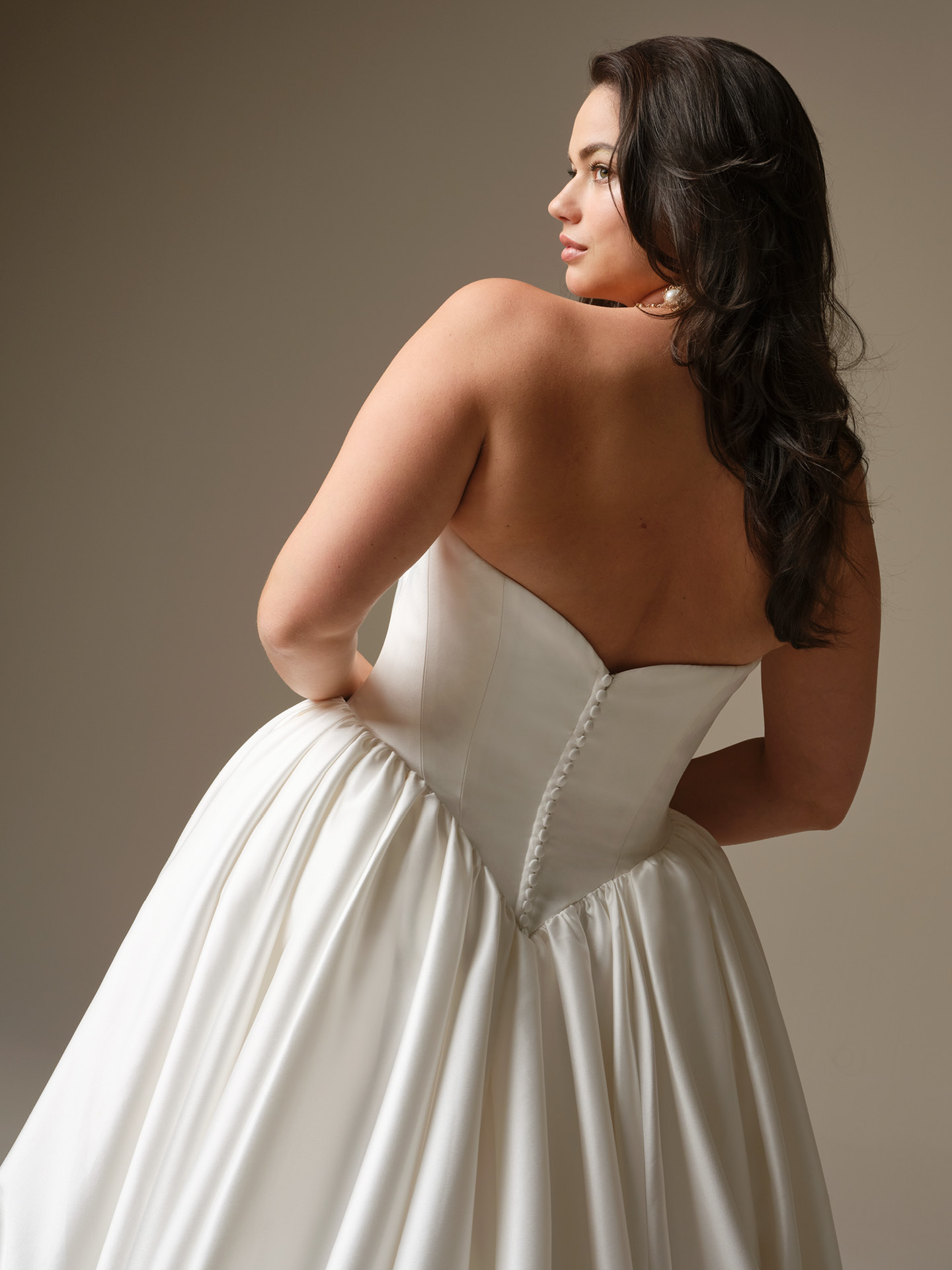 Back view of Maggie Sottero Hudson ballgown wedding dress with a strapless corset, covered button closure, and voluminous skirt, highlighting a smooth, supportive fit with timeless Maggie Magic.