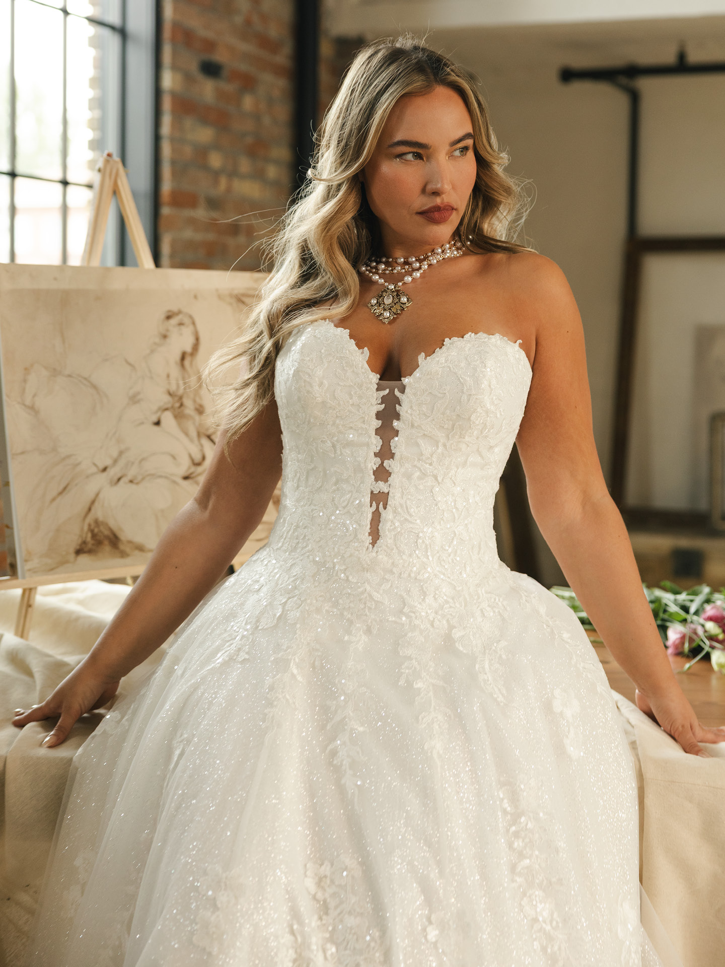 Curvy bride wearing Maggie Sottero Jennifer ballgown wedding dress with a sweetheart neckline, structured corsetry, and a voluminous sparkling skirt, showcasing Maggie Magic fit and inclusive sizing from US 0–28.