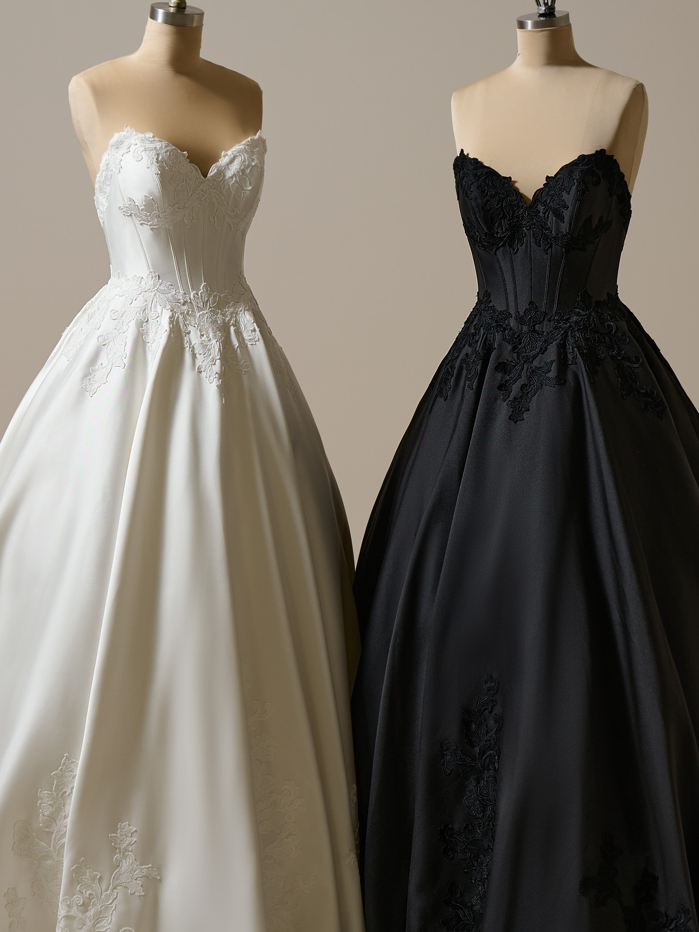 Maggie Sottero Serafina ballgown wedding dress in ivory and black, featuring a strapless corset bodice, structured boning, and a full satin skirt with lace appliqué for a dramatic, sculpted silhouette.