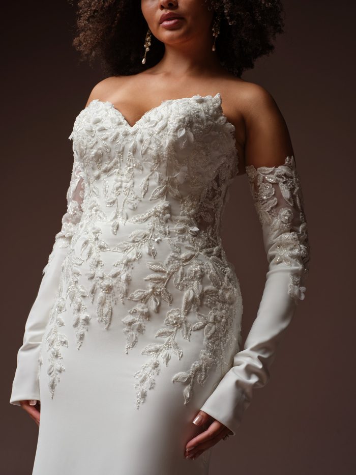 Blair wedding dress long sleeves by Sottero and Midgley featuring fitted detached long sleeves with lace appliqués and sheer illusion detailing, shown in a close-up view.