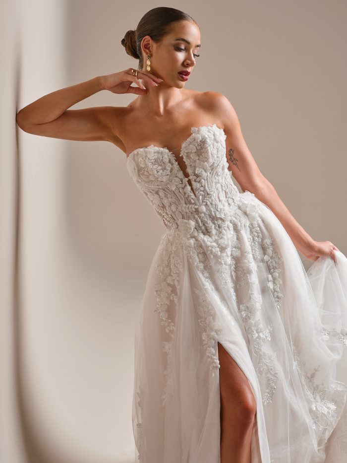 Twilight Lane by Sottero and Midgley A-line wedding dress with strapless sweetheart neckline, 3-D beaded lace over Chantilly lace, illusion plunge bodice, and thigh-high slit.