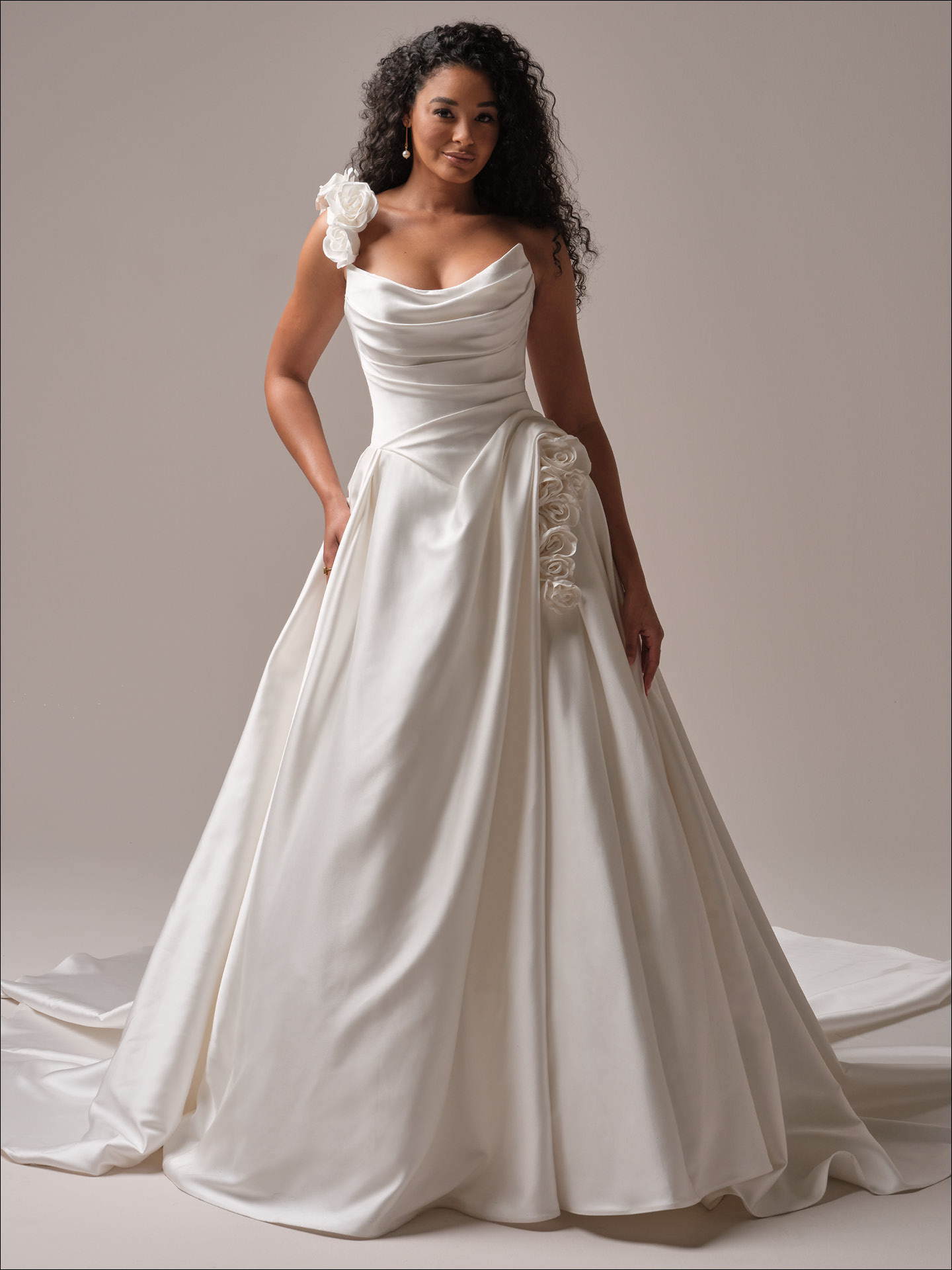 Antoinette by Maggie Sottero ballgown wedding dress with draped strapless neckline, luxe satin skirt, and statement floral accents at the shoulder and hip