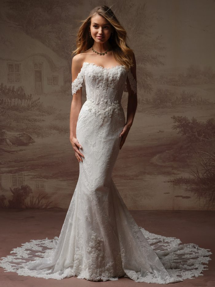 Maggie Sottero Collette sheath wedding dress, front view on model — off-the-shoulder beaded lace bodice with fitted mermaid silhouette and lace-trimmed train.
