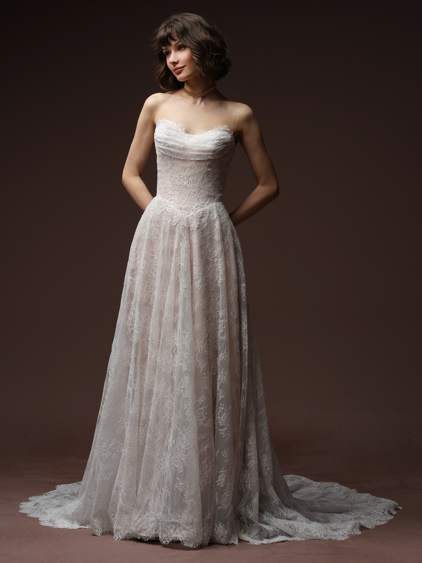 Maggie Sottero Maelle A-line wedding dress in ivory lace, featuring a strapless sweetheart neckline with ruched bodice, fitted lace-appliquéd waist, and a full A-line skirt with a scalloped lace hem.