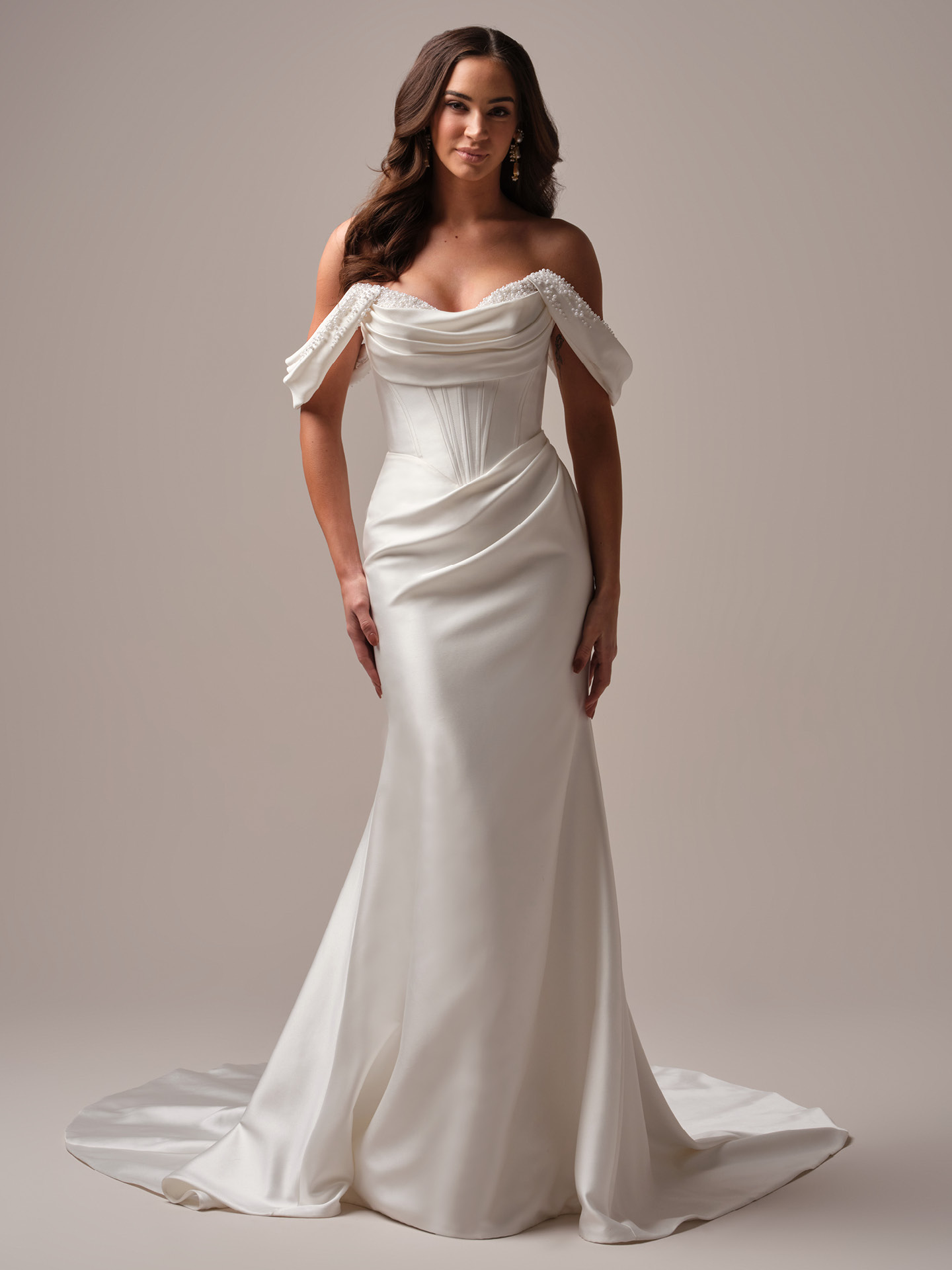 Melissa by Maggie Sottero fit-and-flare satin wedding dress with draped off-the-shoulder sleeves, corset-inspired bodice, and soft scoop neckline