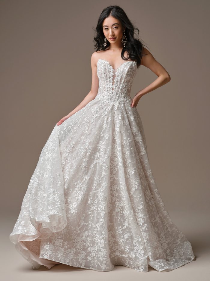 Memphis by Maggie Sottero strapless A-line wedding dress with plunging illusion neckline, floral lace, and flowing tulle skirt
