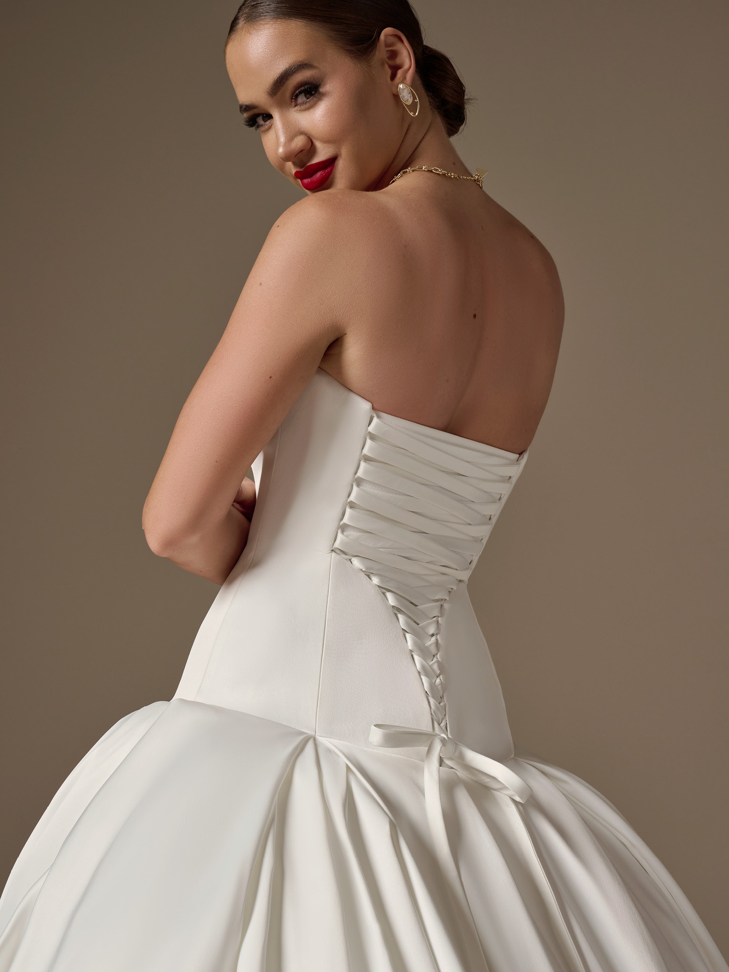 Back view of Adair fit-and-flare wedding dress by Sottero and Midgley with lace-up corset back and voluminous skirt