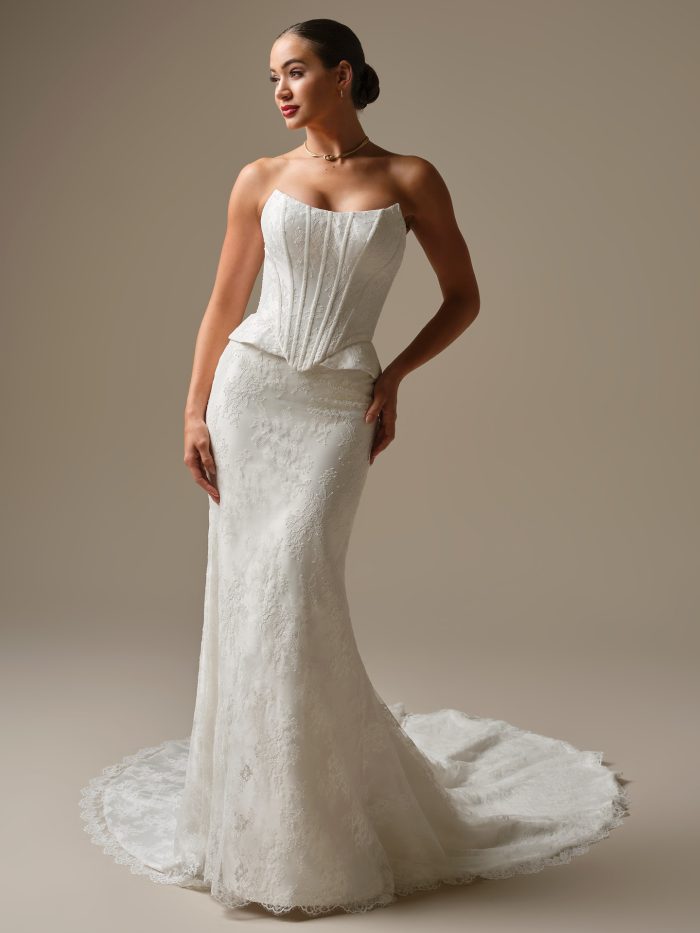 Lassen by Sottero and Midgley strapless Chantilly lace sheath wedding dress with cat eye neckline, corset bodice, and peplum hip detail