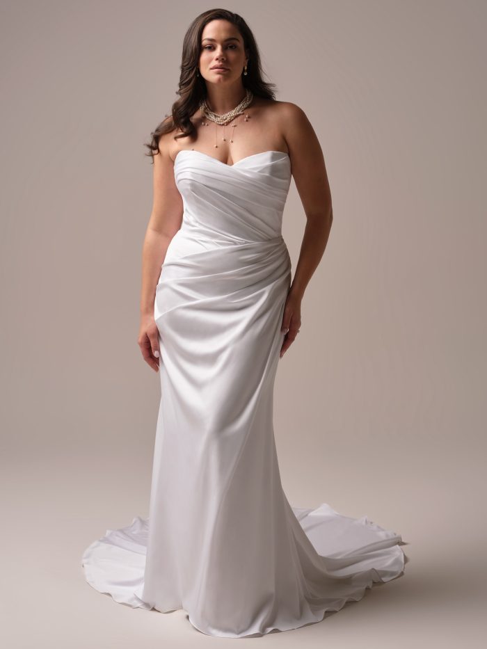 Maggie Sottero Barrington plus size satin goddess wedding dress with strapless sweetheart neckline and asymmetric ruched bodice, curve model