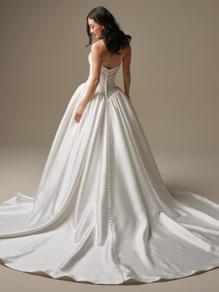 Maggie Sottero Pasadena satin ballgown back view with asymmetric draped bodice, covered buttons and cathedral train