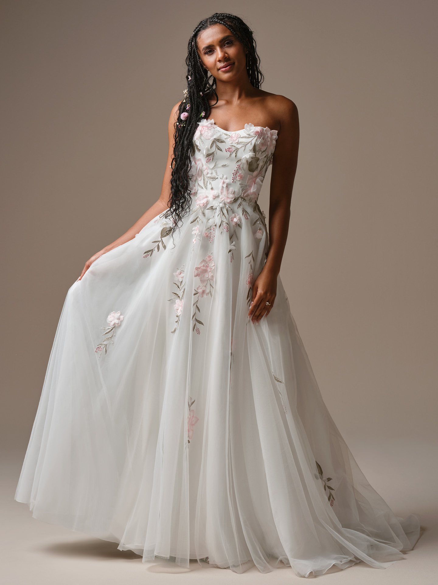 Rebecca Ingram Blossom A-line wedding dress featuring soft tulle layers with delicate pink floral appliqués and a romantic strapless neckline for an airy, garden-inspired bridal look