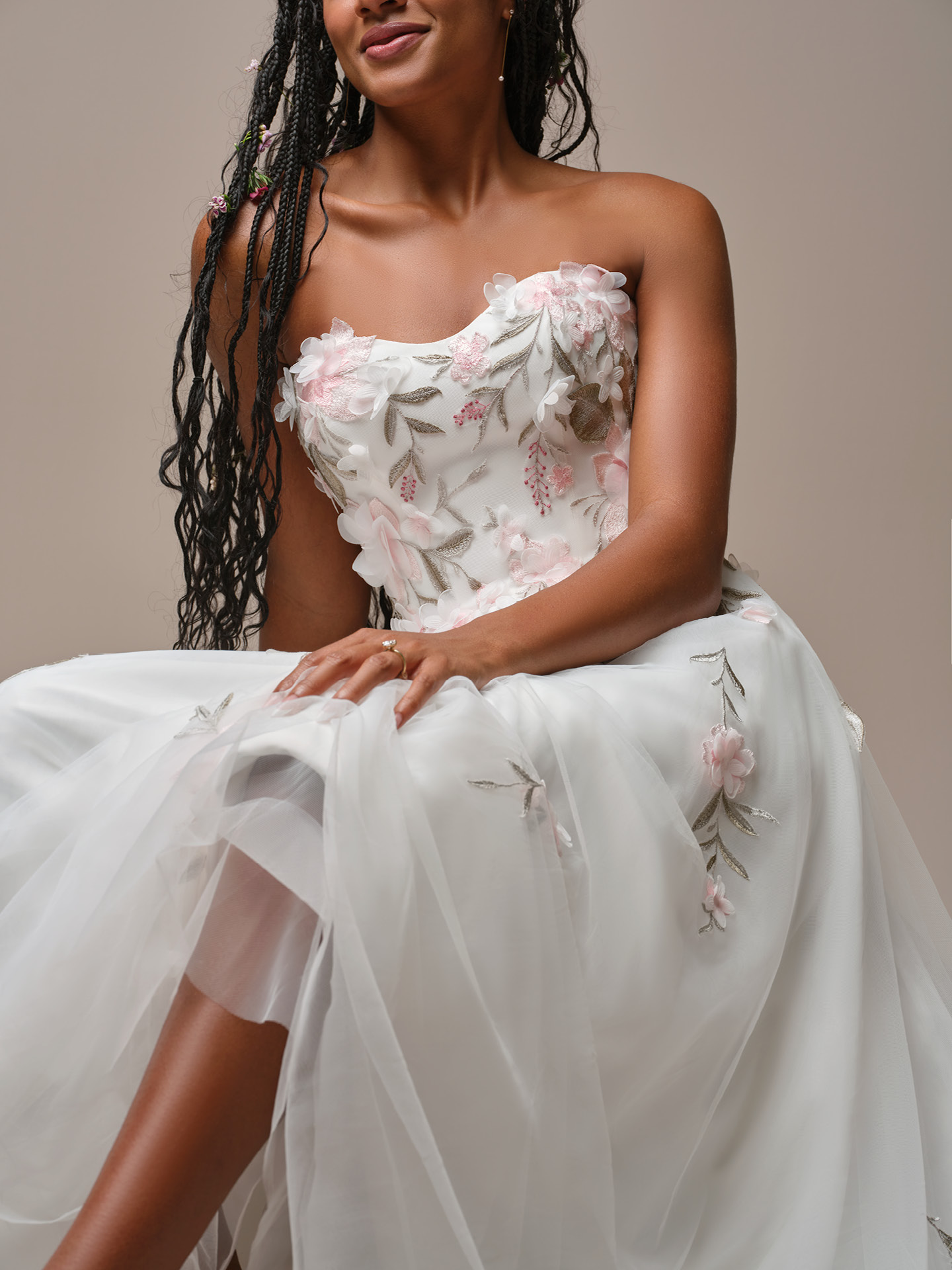 Rebecca Ingram Blossom wedding dress close-up highlighting dimensional floral embroidery, subtle pastel accents, and a softly structured bodice for a whimsical, feminine finish