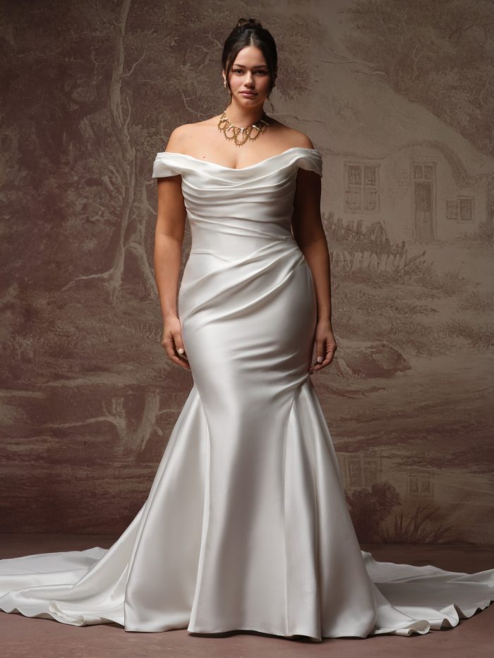 Sottero and Midgley Recine fit-and-flare wedding dress in ivory, curve fit — off-the-shoulder draped cowl neckline with fitted satin mermaid silhouette and sweeping train.