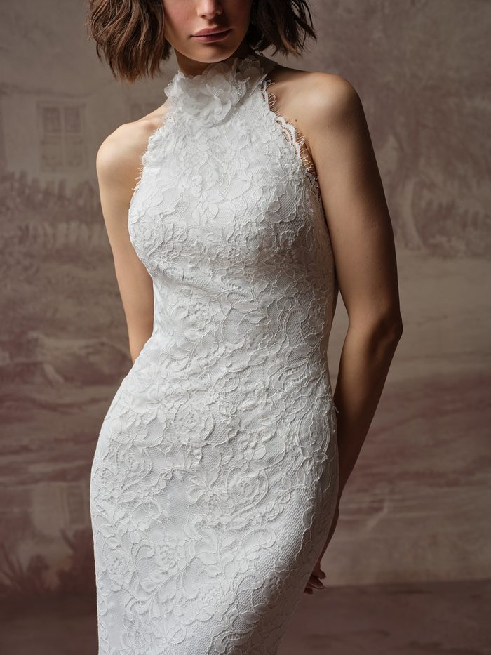 Close-up of the Anya sheath wedding dress by Maggie Sottero, showing the high halter lace neckline with a ruffled collar detail.
