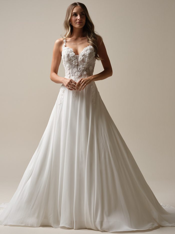 Bride wearing the chiffon Hunter A-line wedding dress by Maggie Sottero, featuring a floral 3D lace bodice with a sweetheart neckline and a flowing ball gown skirt.