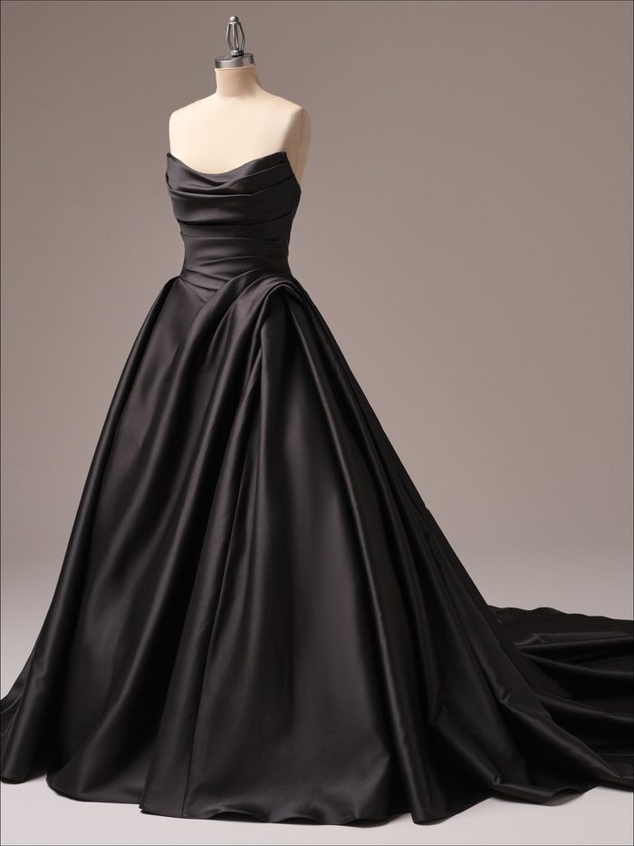 Full-length view of the Maggie Sottero Antoinette ballgown wedding dress in black, featuring a strapless draped satin neckline, ruched bodice, dropped waist, dramatic gathered skirt, and a voluminous ballgown silhouette with an extended train.