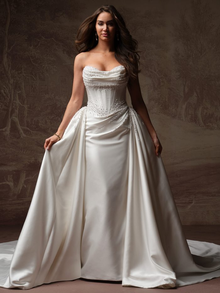 Melissa Royale by Maggie Sottero fit-and-flare wedding dress styled with a dramatic detachable satin overskirt and pearl-beaded corset bodice.