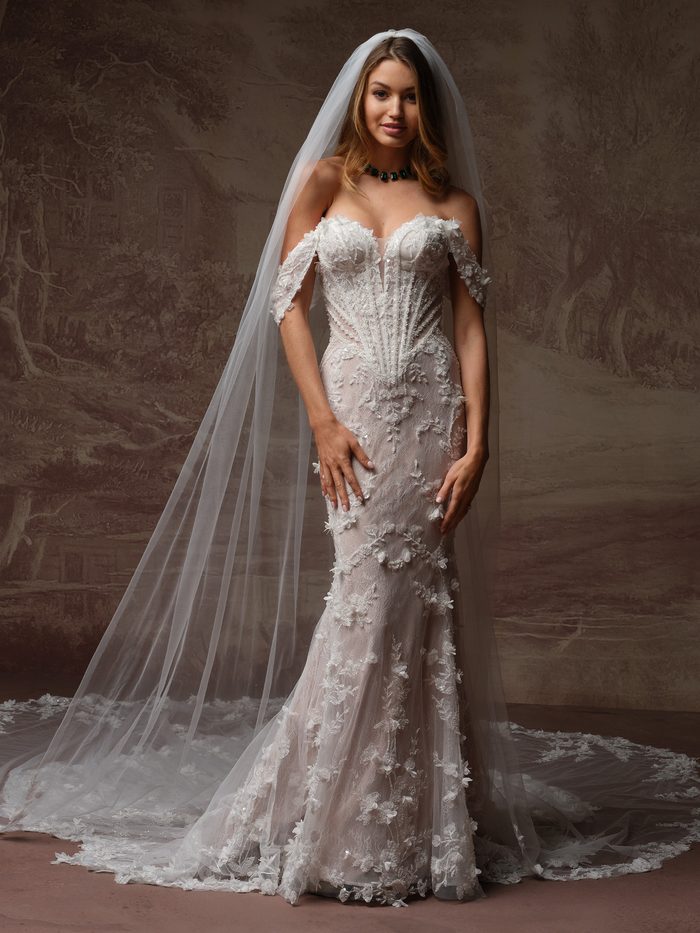Stasia by Maggie Sottero fit-and-flare wedding dress paired with a cathedral-length veil and floral lace appliqués.