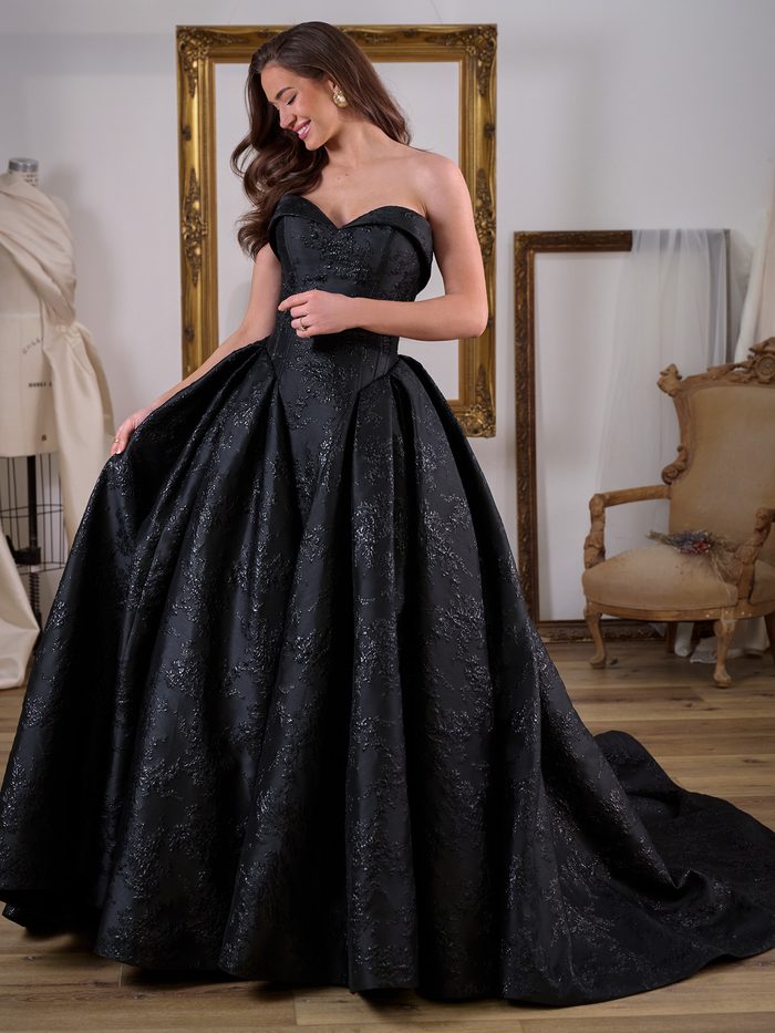 Aberdeen by Sottero and Midgley ballgown wedding dress in black jacquard, featuring a strapless sweetheart neckline, structured corset-inspired bodice, and voluminous skirt with dramatic cathedral-length train. Front view shown in an elegant bridal atelier setting.