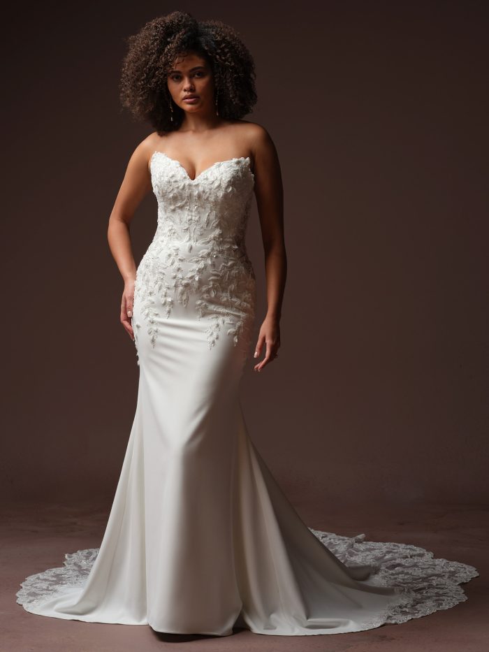 Bride wearing Blair by Sottero and Midgley, a romantic stretch crepe wedding gown with dimensional floral lace embellishments.